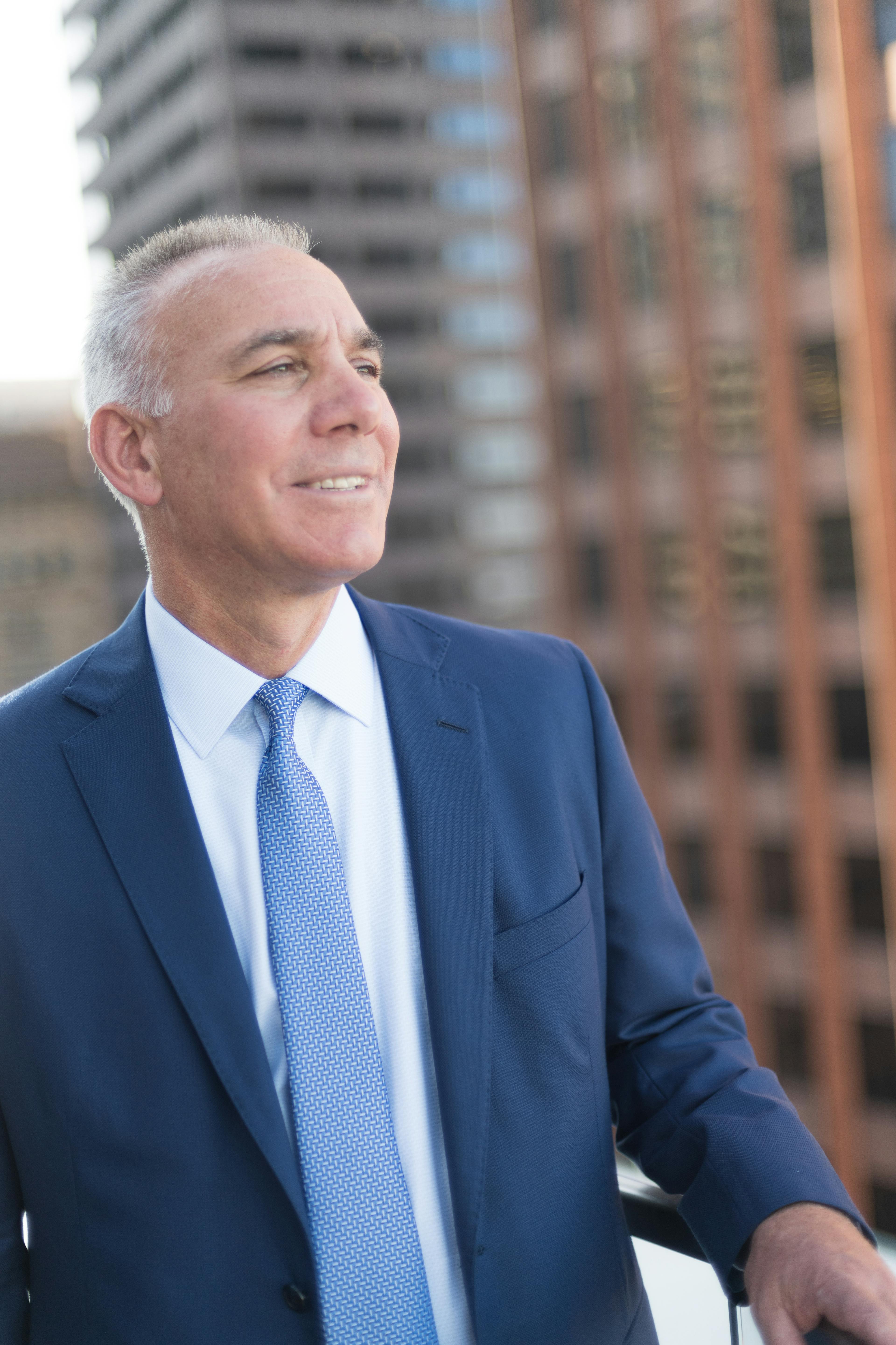 Nixon Peabody CEO and Managing Partner Steve Zubiago, looking to the right, with Boston buildings in the background.